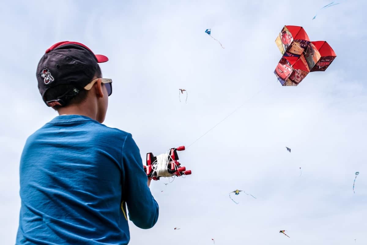 Boy flying box kite
