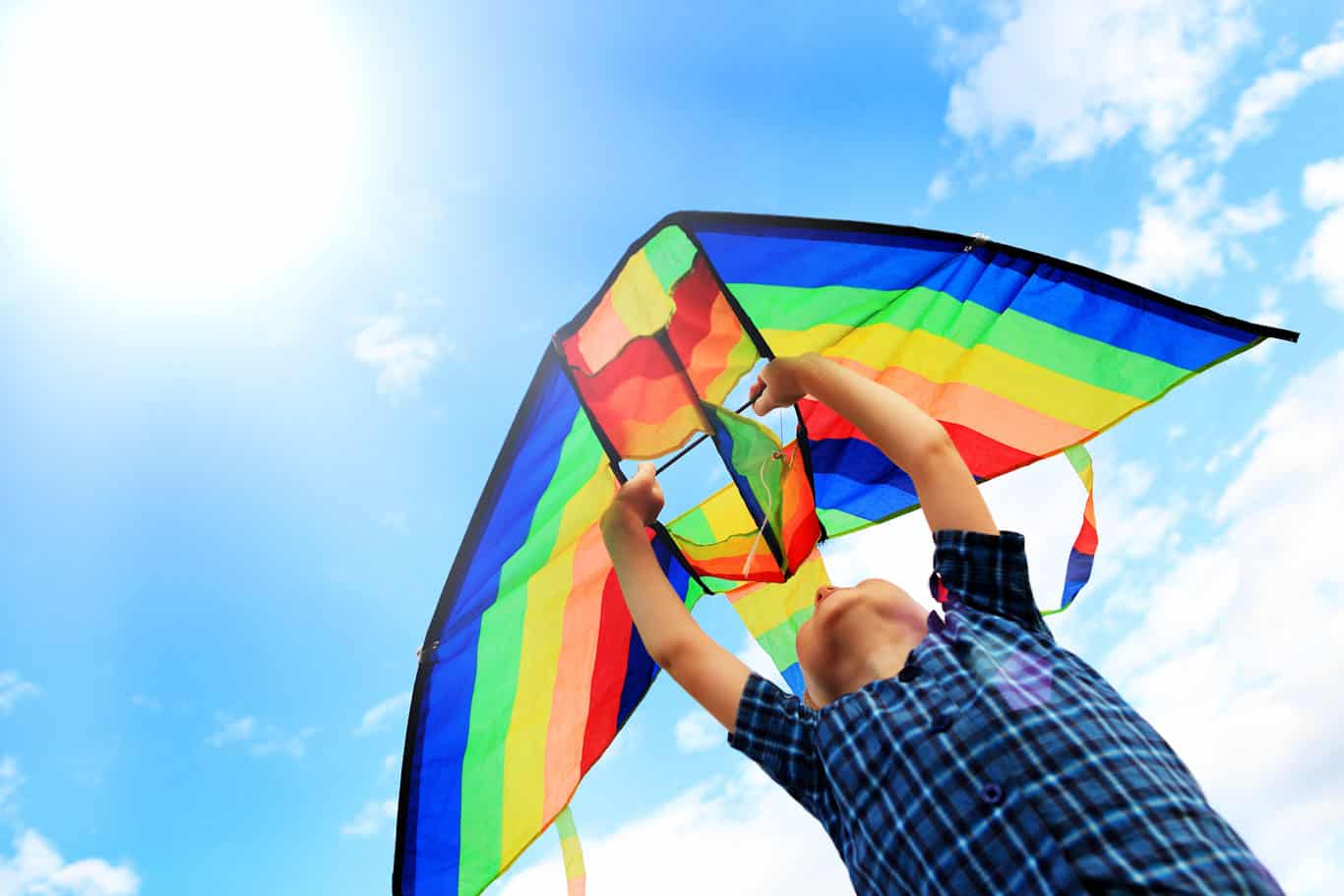 Colorful kite held by boy for launching