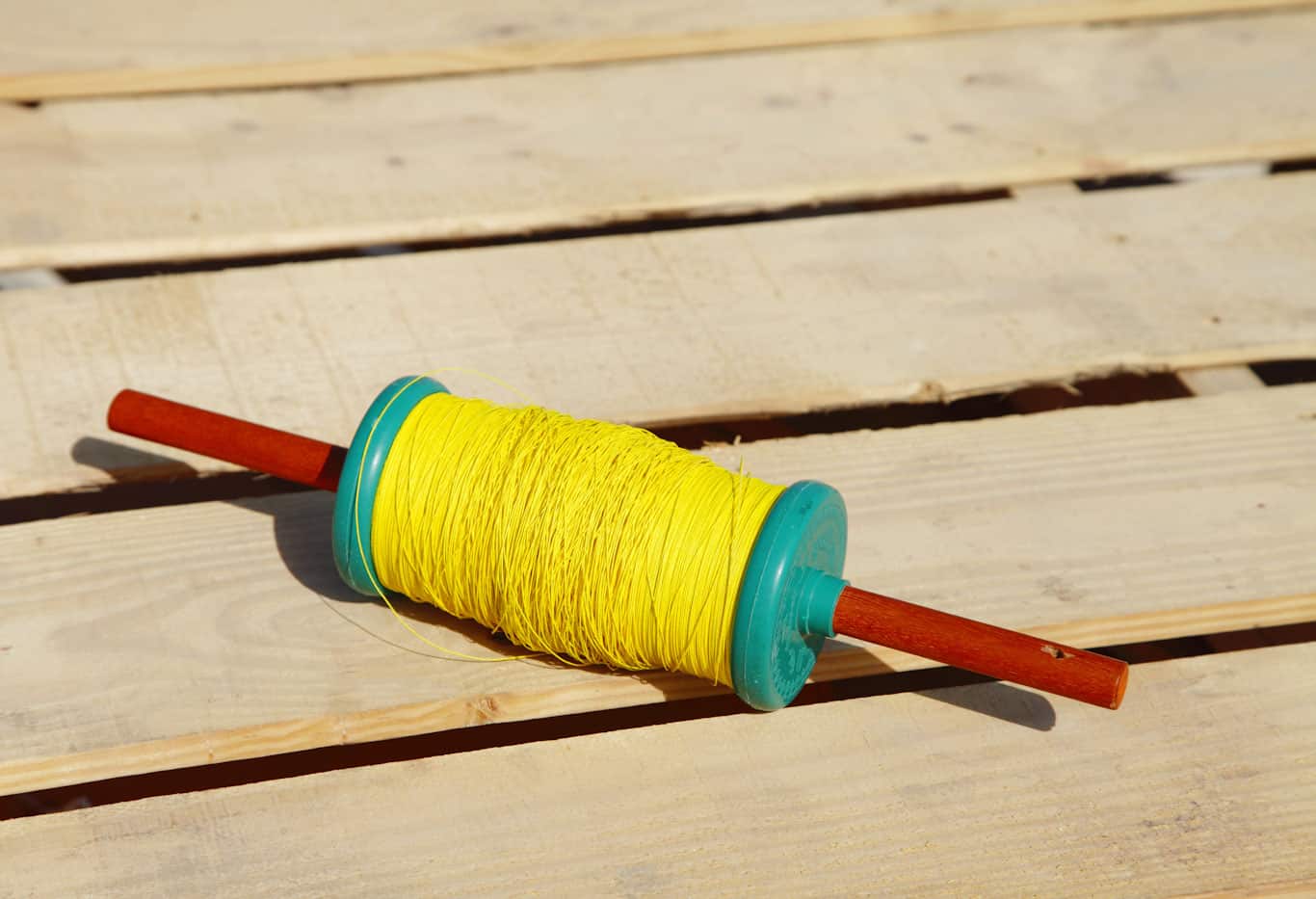 Bright yellow kite string on spool