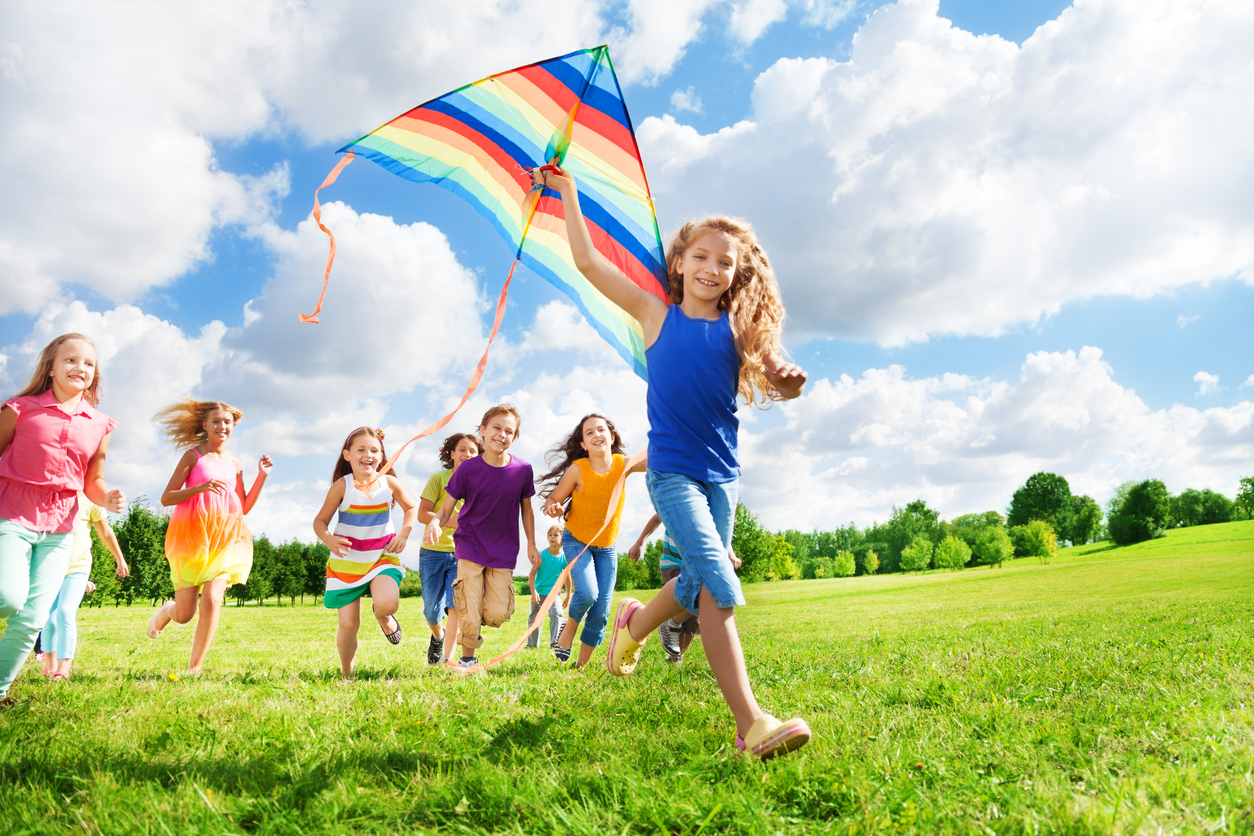 Kids flying a kite in a field